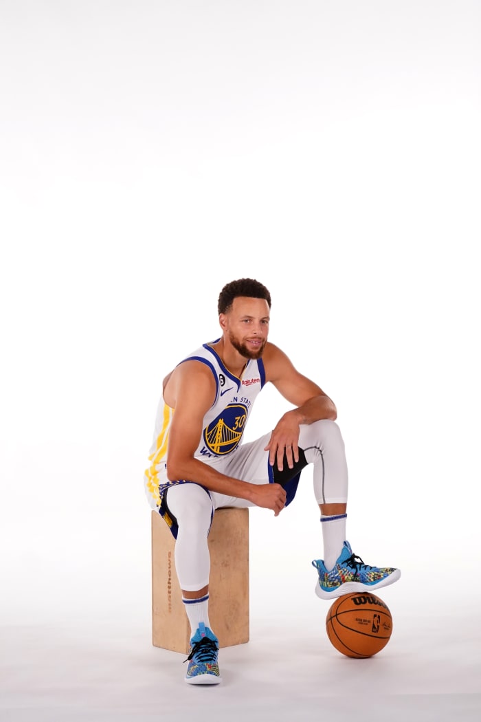 Stephen Curry sits down during photo shoot.